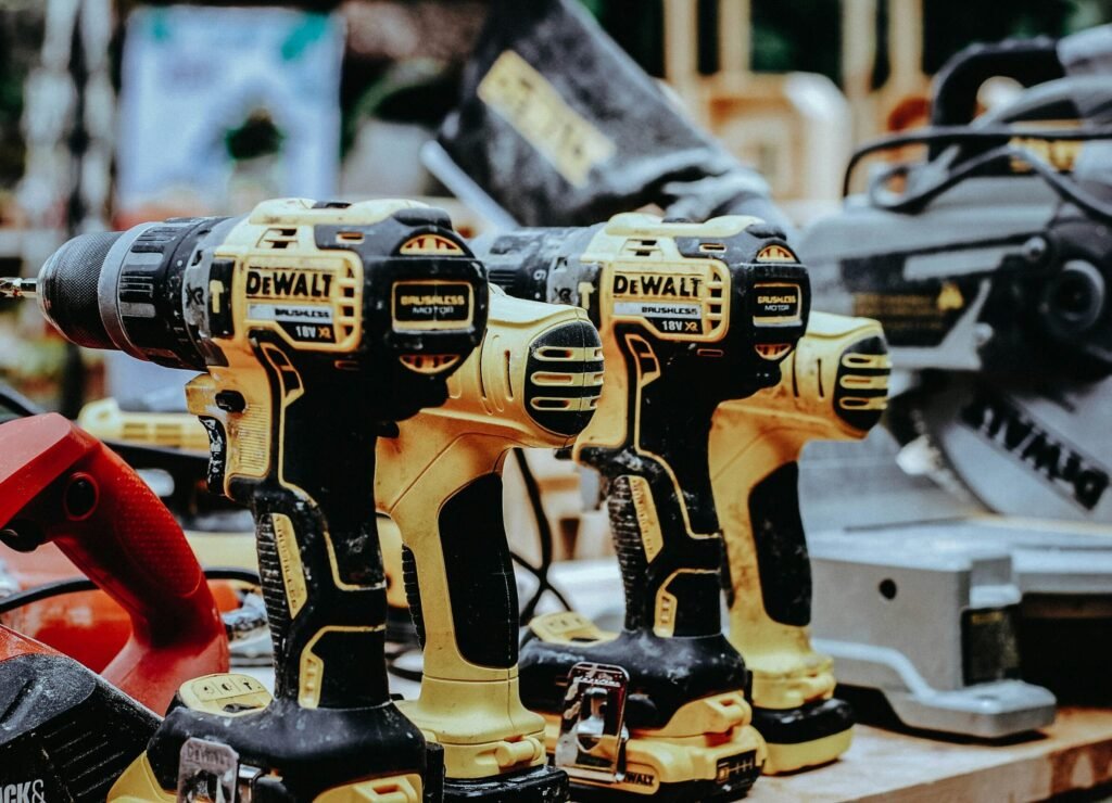 yellow Dewalt hand drills on table